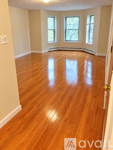 A room with wooden floors and a white door.