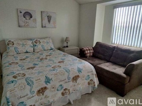 A bedroom with a bed and a couch.