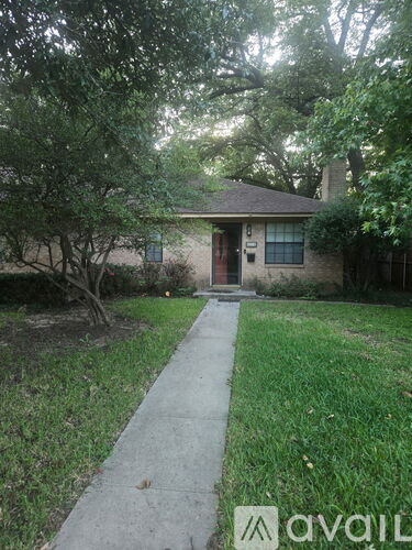 A house with a brown door and a small front yard.