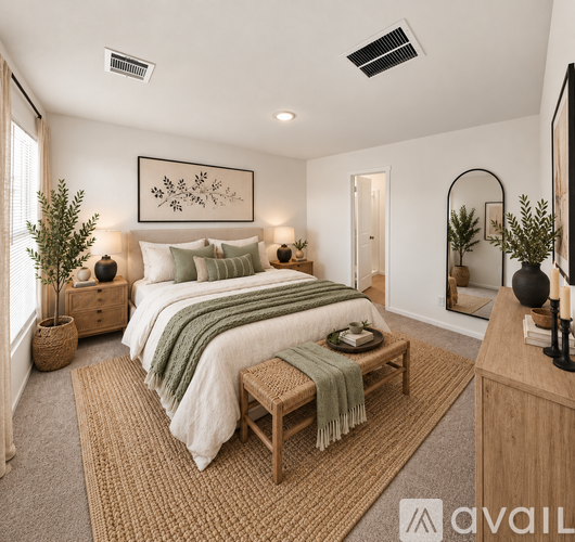 A bedroom with a large bed and a mirror on the wall.