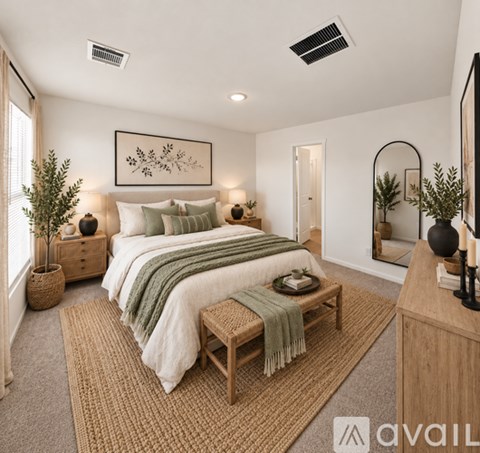 A bedroom with a large bed and a mirror on the wall.