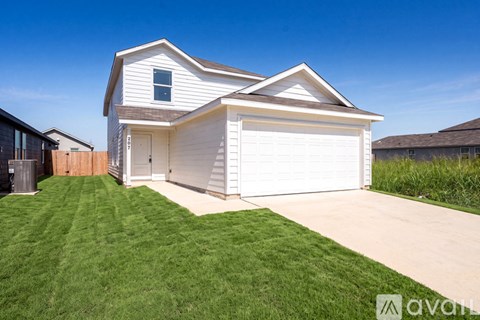 A two-story house with a white garage door.