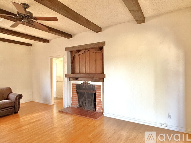 A room with a fireplace and a couch.