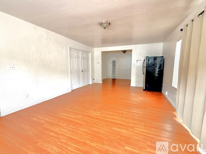 A room with wooden floors and white walls.