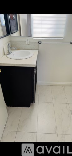 A bathroom with a sink and a mirror.