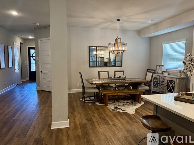 A modern dining room with a wooden table and chairs.