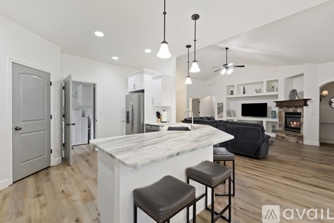 A modern kitchen with a bar area and a fireplace.