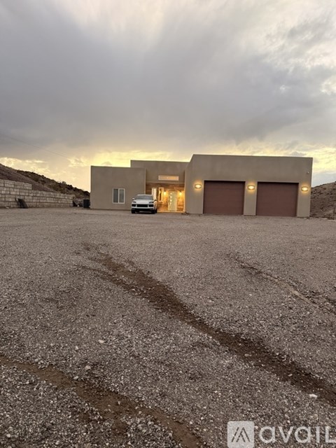 A modern house with a car parked in front.