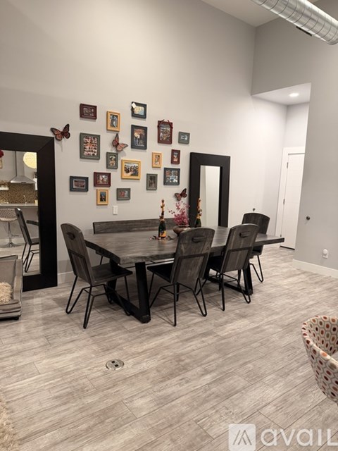 A dining room with a table and chairs.