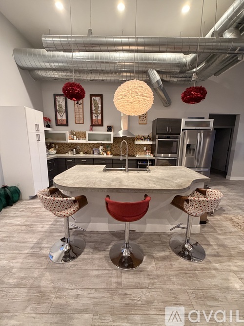 A modern kitchen with a table and chairs in the foreground.