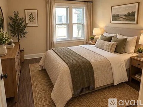 A bedroom with a large bed and a window.
