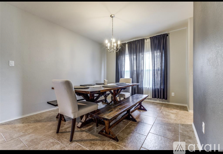 A dining room with a wooden table and chairs.