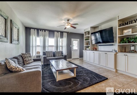 A living room with a grey couch and a coffee table.