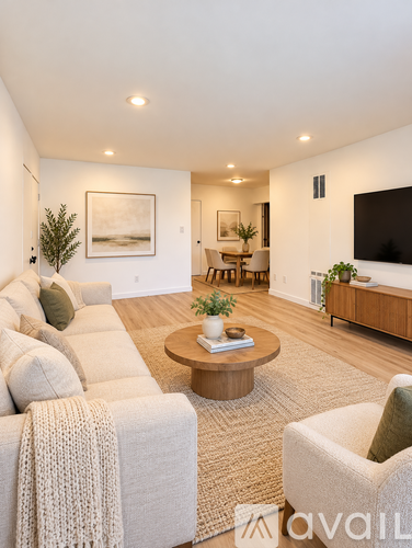 A living room with a couch, a coffee table, and a television.