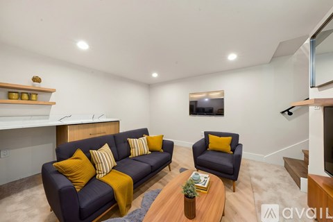 A living room with a blue couch and a wooden coffee table.