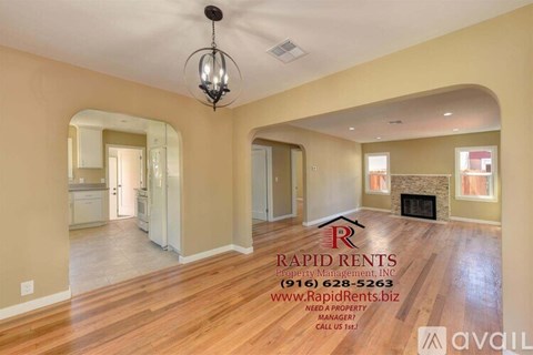 A spacious living room with Rapid Rents Property Management logo and contact information.