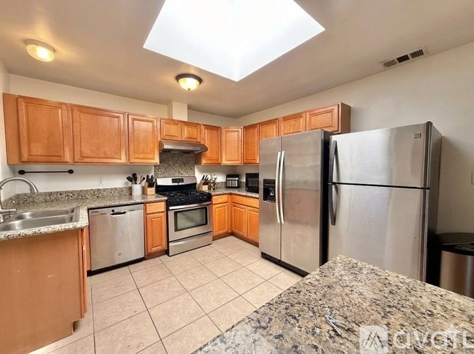 A kitchen with wooden cabinets and stainless steel appliances.