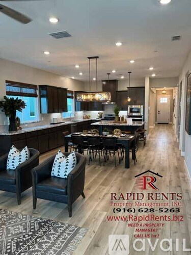A modern kitchen and dining area with a logo for Rapid Rents Property Management.