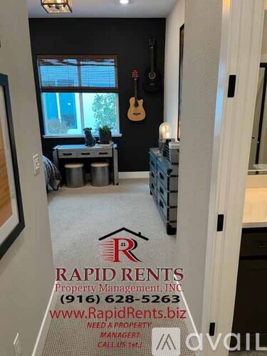 A room with Rapid Rents Property Management, INC logo on the floor.