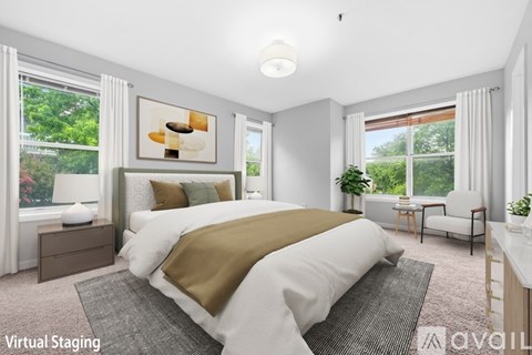 A bedroom with a large bed and a painting on the wall.