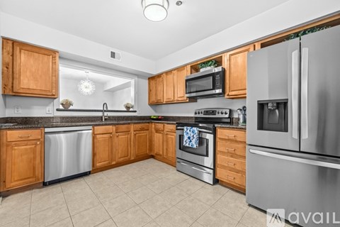 A kitchen with wooden cabinets and stainless steel appliances.