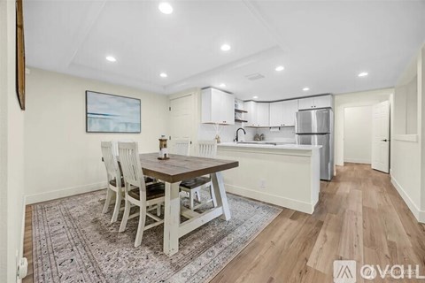 A dining area with a wooden table and chairs.