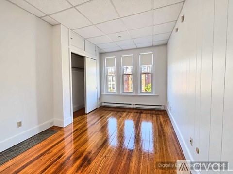 A room with wooden floors and white walls.
