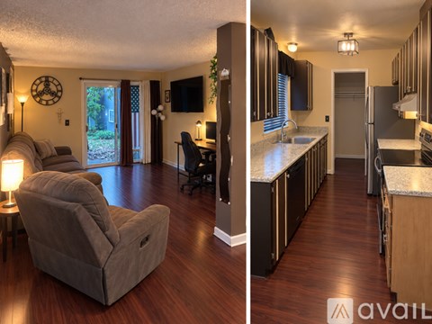 A living room with a couch and a chair, and a kitchen with a refrigerator, sink, and cabinets.