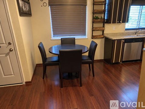 A kitchen with a table and chairs in the foreground.