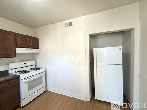 A kitchen with a white stove and a white refrigerator.
