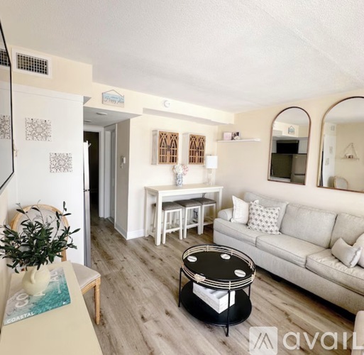 A living room with a white couch and a coffee table.