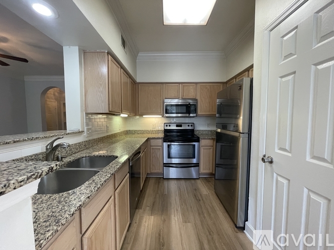 A kitchen with wooden cabinets and stainless steel appliances.