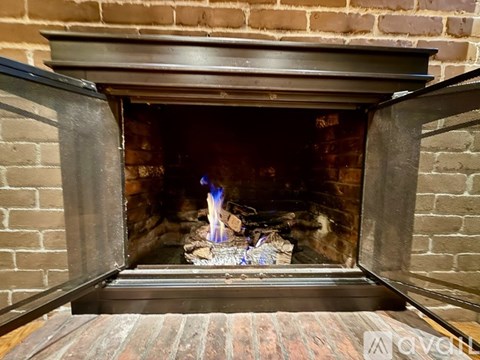 A fireplace with a fire burning inside.