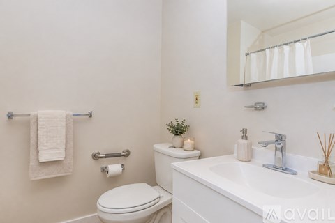A white toilet sits next to a sink in a bathroom.