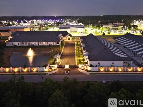 A large building complex with a lit walkway in front.