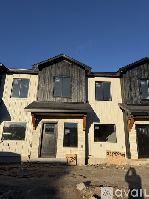 A row of houses under construction with the name "Jefferson" on the front of the middle one.