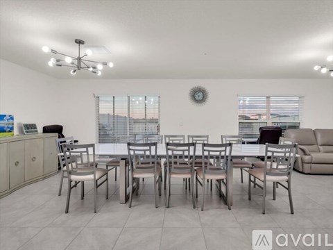 A dining room with a table set for six.