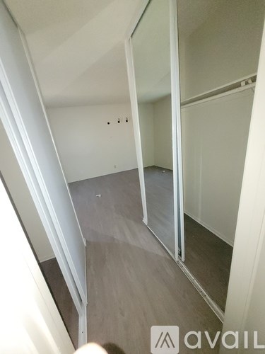 A room with a glass door and a wooden floor.