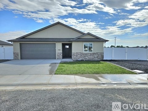 A house with a garage and a driveway in front.