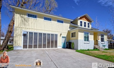 A two-story house with a garage is for sale.