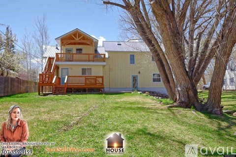 A house with a yellow and white exterior is for sale.