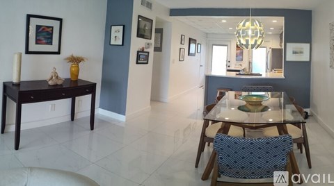A dining room with a table and chairs.