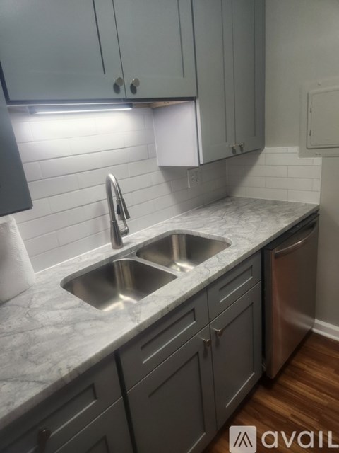 A kitchen with a sink and a dishwasher.
