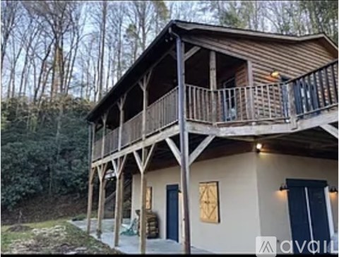 A wooden house with a balcony and a porch.