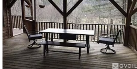 A wooden deck with a table and two chairs.