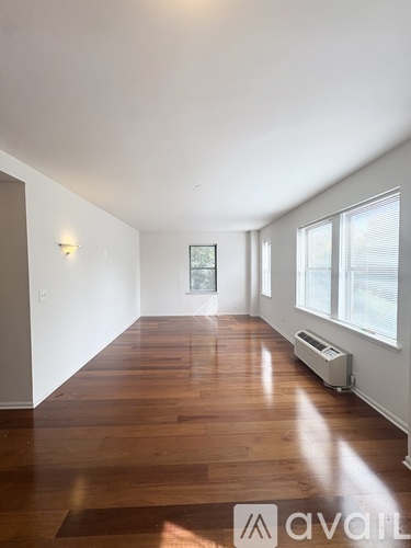 A room with wooden floors and a window.