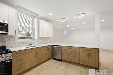 A kitchen with wooden cabinets and a black stove top oven.
