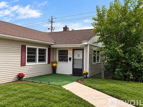A house with a green lawn and a white door.