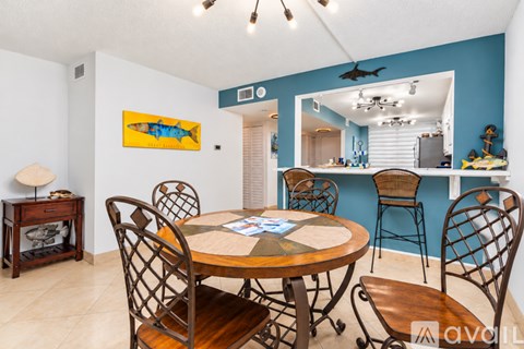 A dining room with a wooden table and chairs.