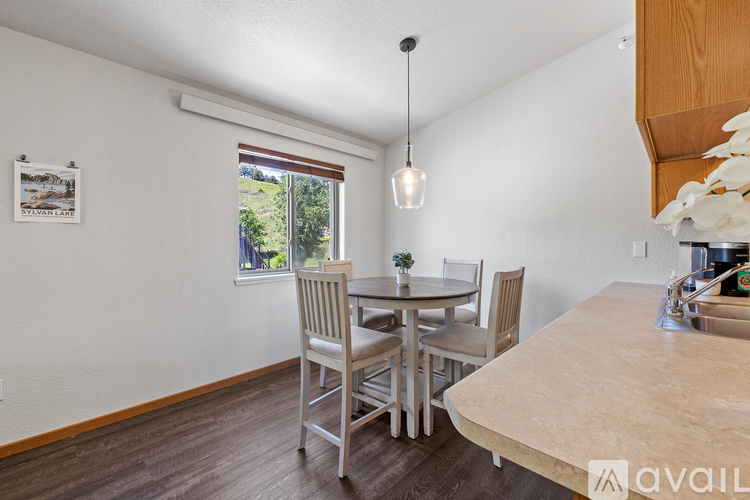 A dining room with a table set for four.